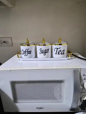 three cans of coffee and sugar tea on top of a microwave at ZEN 2 SHORE RESIDENCES Tower A in Manila