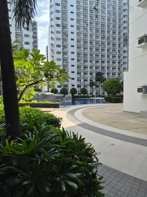 a street in a city with tall buildings at ZEN 2 SHORE RESIDENCES Tower A in Manila