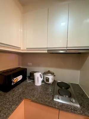 a kitchen counter with a stove and a toaster at Place to stay in Pasay in Manila