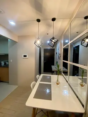a dining room with a table and some lights at Place to stay in Pasay in Manila