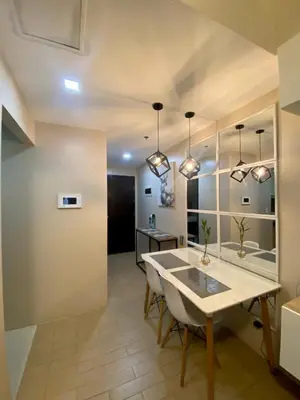 a dining room with a table and some lights at Place to stay in Pasay in Manila