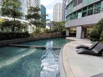 a pool in the middle of a building at Charming 2-BR Condo in BGC in Manila