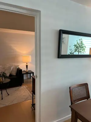 a living room with a couch and a mirror on the wall at Charming 1-BR in BGC in Manila