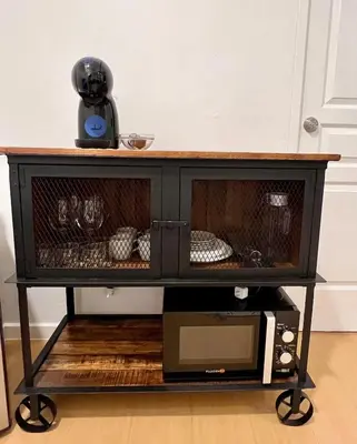 a black coffee table with a microwave on a shelf at Charming 1-BR in BGC in Manila