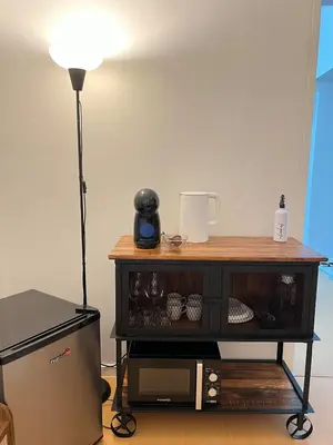 a black table with a lamp on top of it at Charming 1-BR in BGC in Manila