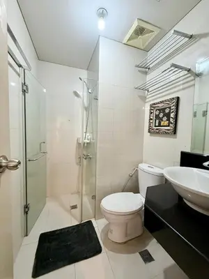 a bathroom with a toilet and a shower and a sink at Apartment near Airport at One Palm Tree Villas in Manila