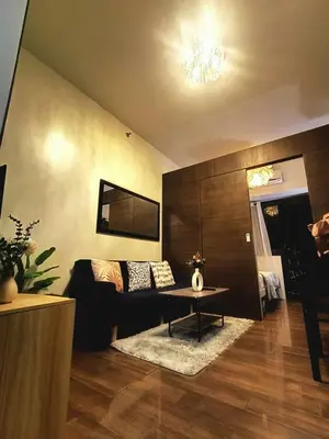 a living room with a couch and a table at AIR RESIDENCES MAKATI Staycation in Manila