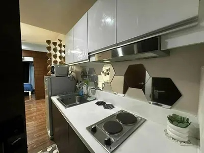 a kitchen with a sink and a stove top oven at AIR RESIDENCES MAKATI Staycation in Manila