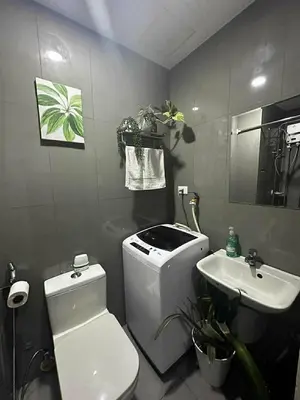 a bathroom with a white toilet and a sink at AIR RESIDENCES MAKATI Staycation in Manila