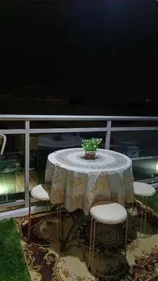 a table and four chairs on a balcony at AZURE RESIDENCES near International AIRPORT MANILA in Manila