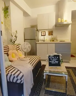 a living room with a couch and a kitchen at AZURE RESIDENCES near International AIRPORT MANILA in Manila
