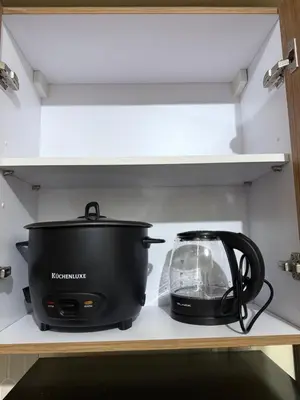a pot and a toaster on a shelf in a kitchen at 1BR Staycation at Avida Towers SM Sucat in Manila