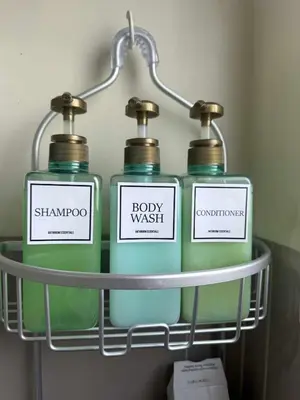 a group of four bottles of soap on a shelf at 1BR Staycation at Avida Towers SM Sucat in Manila