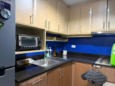 a kitchen with a sink and a microwave at 1 Bedroom Apartment Across NAIA T3 in Manila