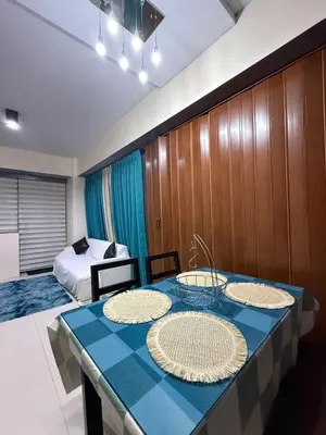 a room with a table with two plates on it at 1 Bedroom Apartment Across NAIA T3 in Manila