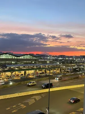 a view of a city with cars on a highway at 1 Bedroom Apartment Across NAIA T3 in Manila