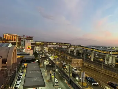 a busy city street with cars on the road at 1 Bedroom Apartment Across NAIA T3 in Manila