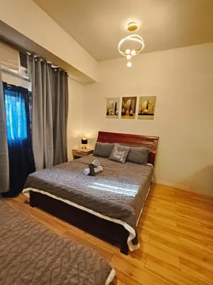a bedroom with a bed and a window at Holland Park staycation in Jalang