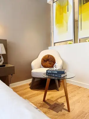 a living room with a chair and a glass table at Metro Suites at Novotel Suites Acqua in Manila