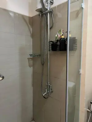 a shower with a glass door in a bathroom at DMV Trinity Stay in Manila