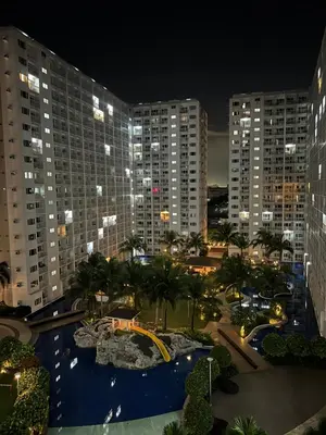 a view of a city at night with tall buildings at DMV Trinity Stay in Manila
