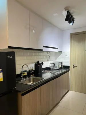a kitchen with a sink and a counter top at DMV Trinity Stay in Manila