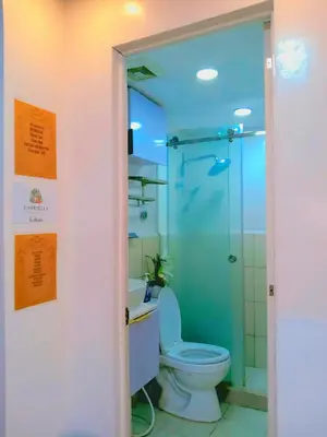 a bathroom with a toilet and a shower at Gabrielle Staycation in Imus