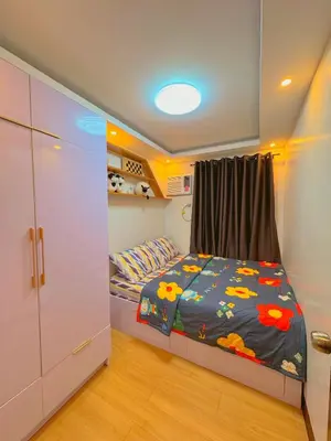 a small bedroom with a bed and a closet at Gabrielle Staycation in Imus