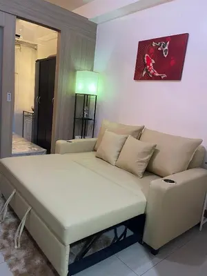 a living room with a couch and a table at Casa California by AC Haven in Shore Residences near MOA Pasay City in Manila