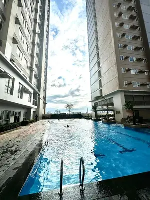 a swimming pool in the middle of two buildings at Candice Empire Garden in Manila
