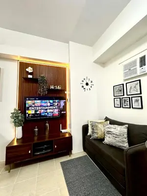 a living room with a couch and a flat screen tv at Candice Empire Garden in Manila