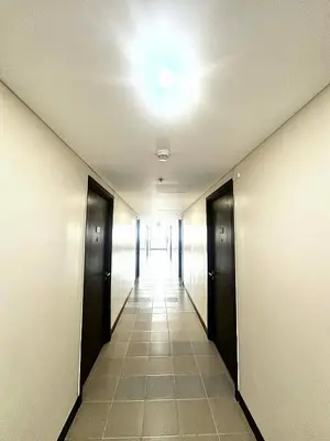 an empty hallway with doors and a light on the ceiling at Candice Empire Garden in Manila