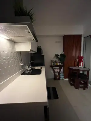 a kitchen with a sink and a counter top at Azure Luxury Condo in Manila