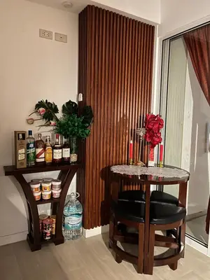 a room with a table and a chair and a window at Azure Luxury Condo in Manila