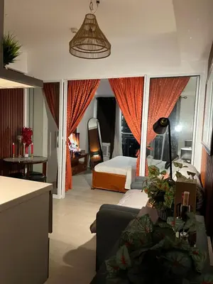 a bedroom with a bed and a couch in a room at Azure Luxury Condo in Manila