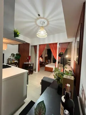 a living room with a couch and a bed at Azure Luxury Condo in Manila
