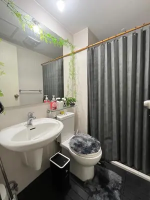 a bathroom with a sink and a toilet and a shower at Azure Luxury Condo in Manila