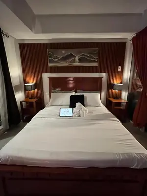 a bedroom with a bed with a laptop on it at Azure Luxury Condo in Manila