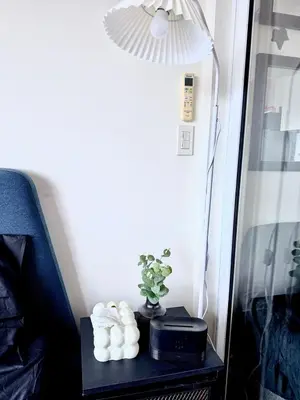 a table with a lamp and a plant on it at Modern Condo in Makati with Stylish City Escape in Manila