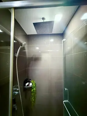 a bathroom with a shower with a ceiling at Modern Condo in Makati with Stylish City Escape in Manila