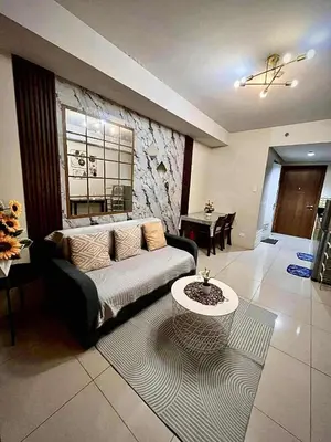a living room with a couch and a table at Jeff staycation in Manila