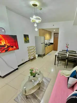 a living room with a couch and a fireplace at Jeff staycation in Manila