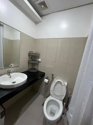 a bathroom with a toilet and a sink at Jeff staycation in Manila