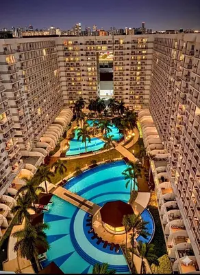 an aerial view of a large building with a swimming pool at Jeff staycation in Manila
