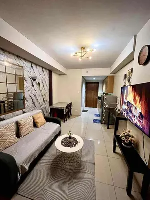 a living room with a couch and a table at Jeff staycation in Manila