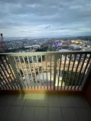 a bench on a balcony with a view of a city at Near Vista Mall Taguig BGC with Overlooking Veranda Netflix and Pay Parking in Manila