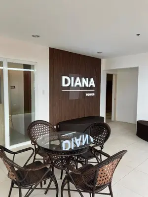 a glass table and chairs in front of a store at Near Vista Mall Taguig BGC with Overlooking Veranda Netflix and Pay Parking in Manila