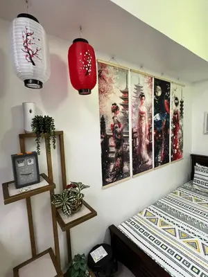 a bedroom with two twin beds with posters on the wall at Near Vista Mall Taguig BGC with Overlooking Veranda Netflix and Pay Parking in Manila