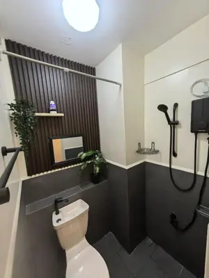 a bathroom with a toilet and a shower at FSZAirbnb in Manila