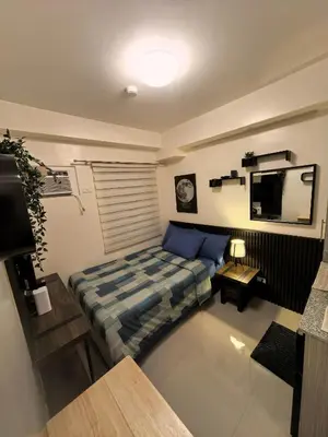 a small room with a bed and a television at FSZAirbnb in Manila